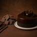 Bakels Chockex Dark Compound Chocolate 10KG | Premium Baking Coating Chocolate on a cake with chocolate curls