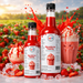 Strawberry dessert topping bottles and dessert in a vibrant strawberry field, ideal for thickshakes, sundaes, and drinks.