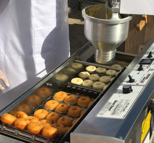 Classic Cake Donut Mix | World’s Best Tasting Donut Mix being used in a professional donut fryer.