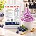 Blueberry Soft Serve 1KG bag with soft serve dessert and flavour ingredients in a café setting