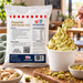 Spoon lifting pistachio soft serve from a cup beside the Pistachio Soft Serve Mix 1kg pouch and nuts