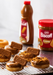Lotus Biscoff spread 3kg donuts topped with Biscoff biscuits and crumbs on cooling rack in professional kitchen setting